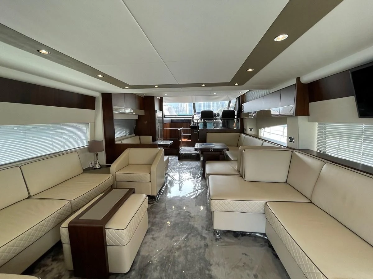 a living room with a couch and a tv aboard FAIRLINE SQUADRON 65 Yacht for Sale
