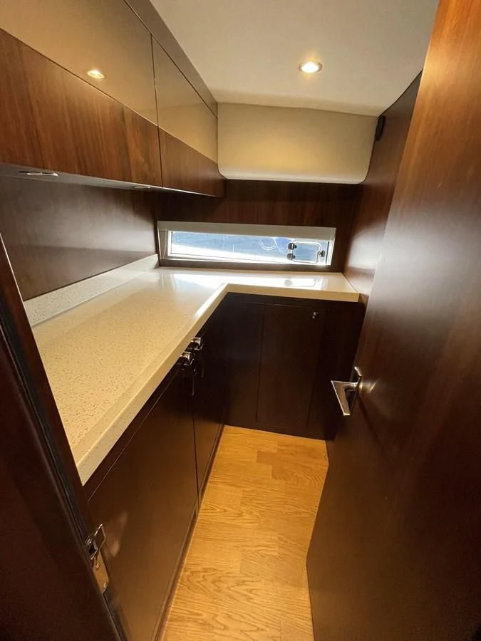 a kitchen with a large microwave aboard FAIRLINE SQUADRON 65 Yacht for Sale