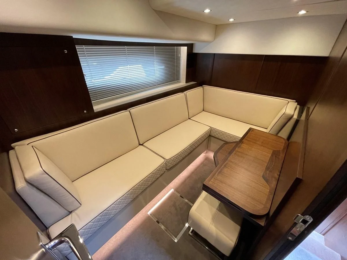 a room with a table and chairs aboard FAIRLINE SQUADRON 65 Yacht for Sale