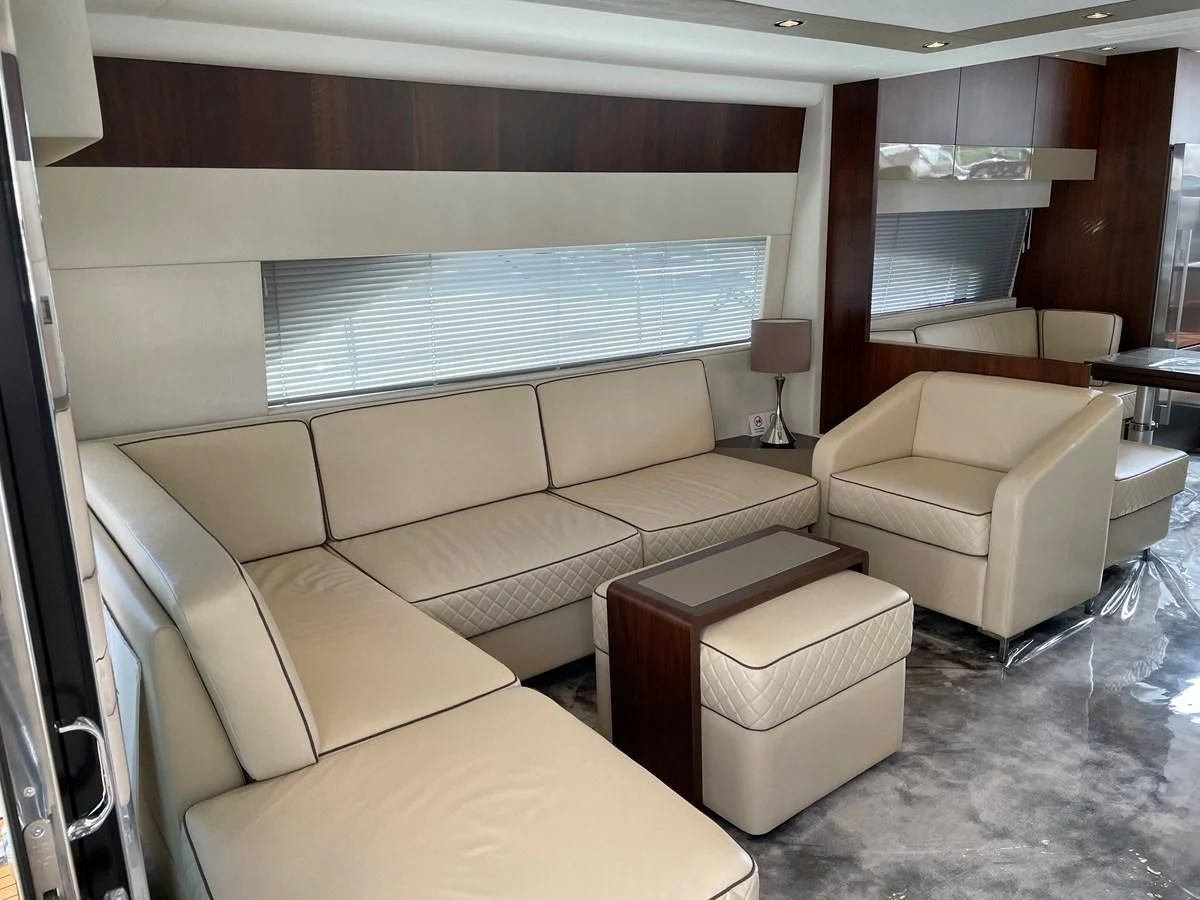 a living room with a couch and a table aboard FAIRLINE SQUADRON 65 Yacht for Sale