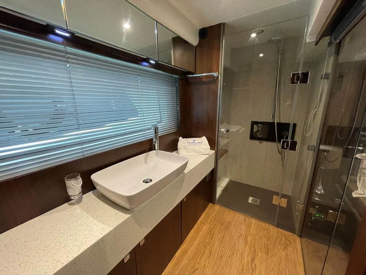a bathroom with a glass shower aboard FAIRLINE SQUADRON 65 Yacht for Sale