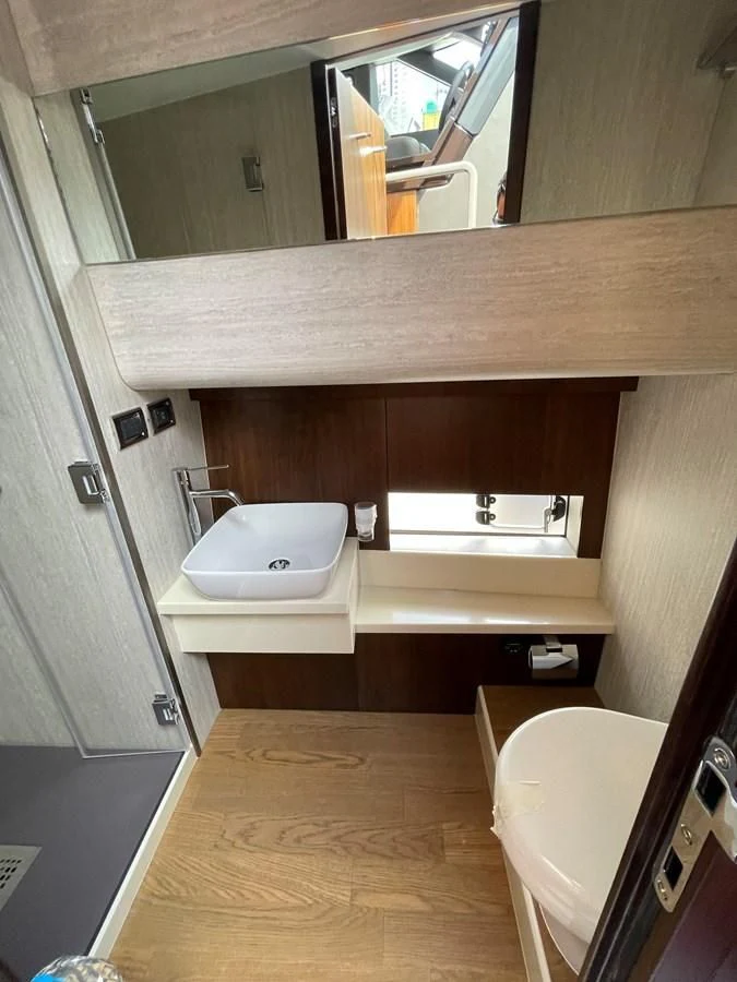 a bathroom with a sink and a mirror aboard FAIRLINE SQUADRON 65 Yacht for Sale