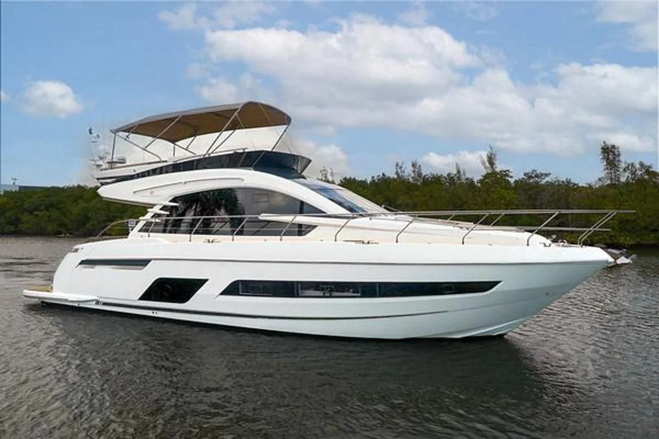 a white yacht on a beach aboard FAIRLINE SQUADRON 65 Yacht for Sale