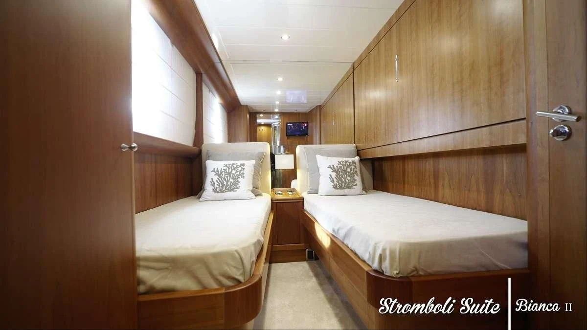 a couple of beds in a room aboard BIANCA II Yacht for Charter