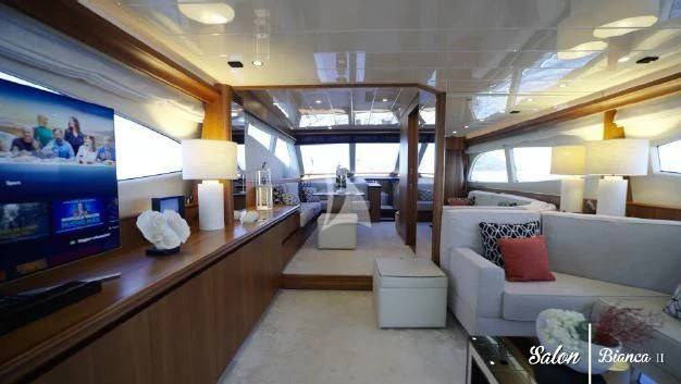 a room with a couch and a television aboard BIANCA II Yacht for Charter
