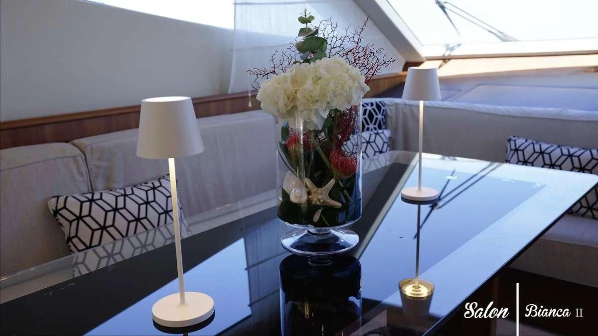 a vase of flowers on a table aboard BIANCA II Yacht for Charter