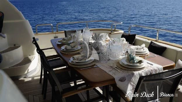 a table set for a dinner on a boat aboard BIANCA II Yacht for Charter