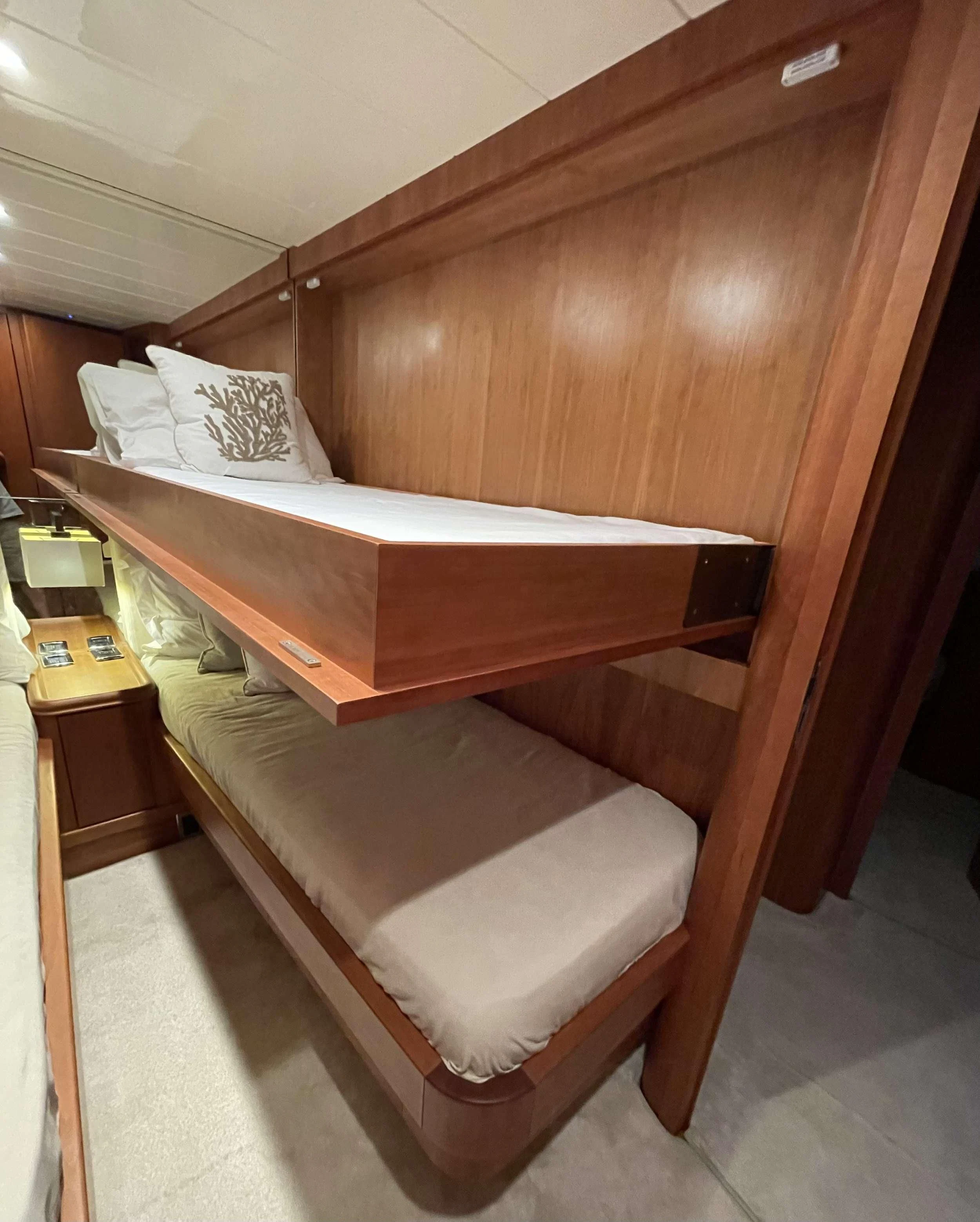 a bed with a wooden frame aboard BIANCA II Yacht for Charter