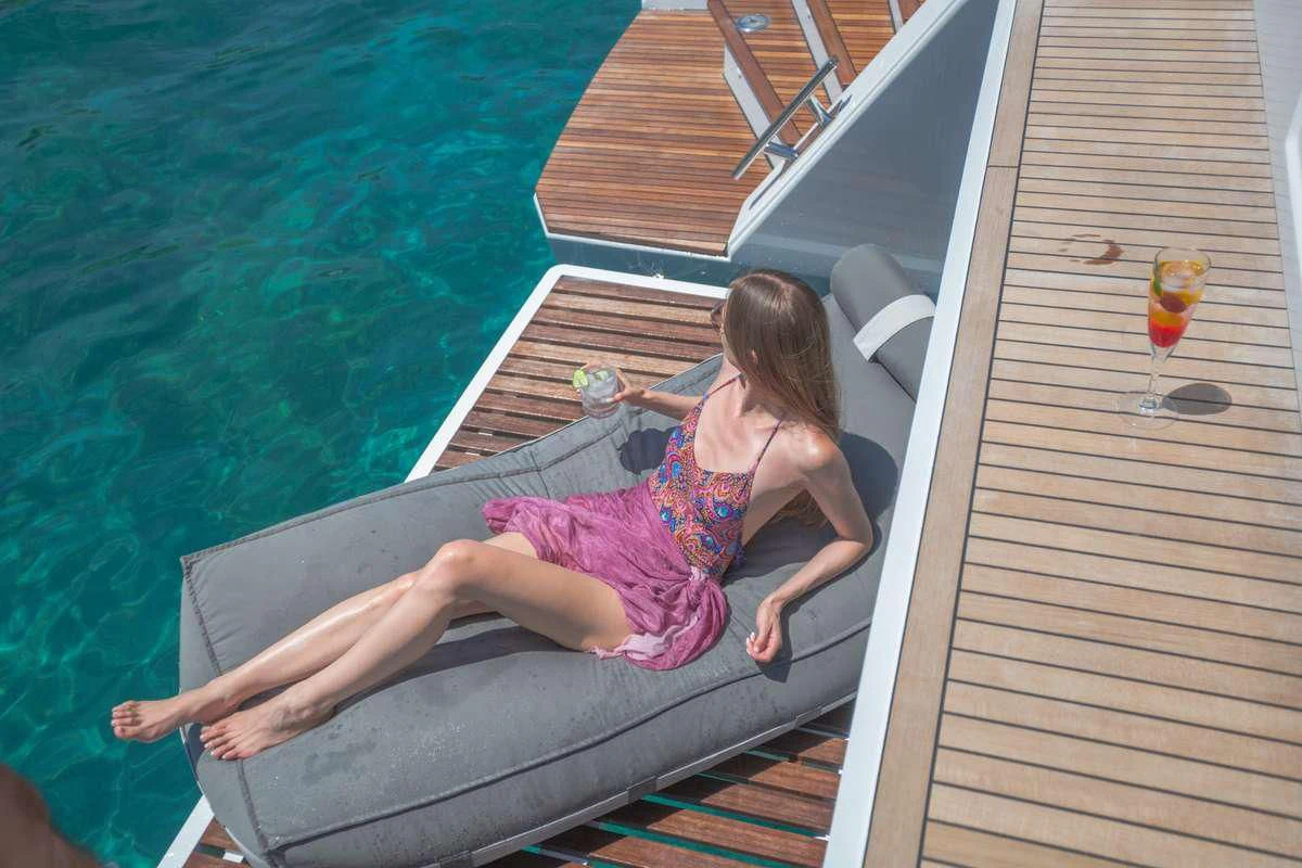 a girl sitting on a bench aboard MAJESTY OF GREECE Yacht for Charter