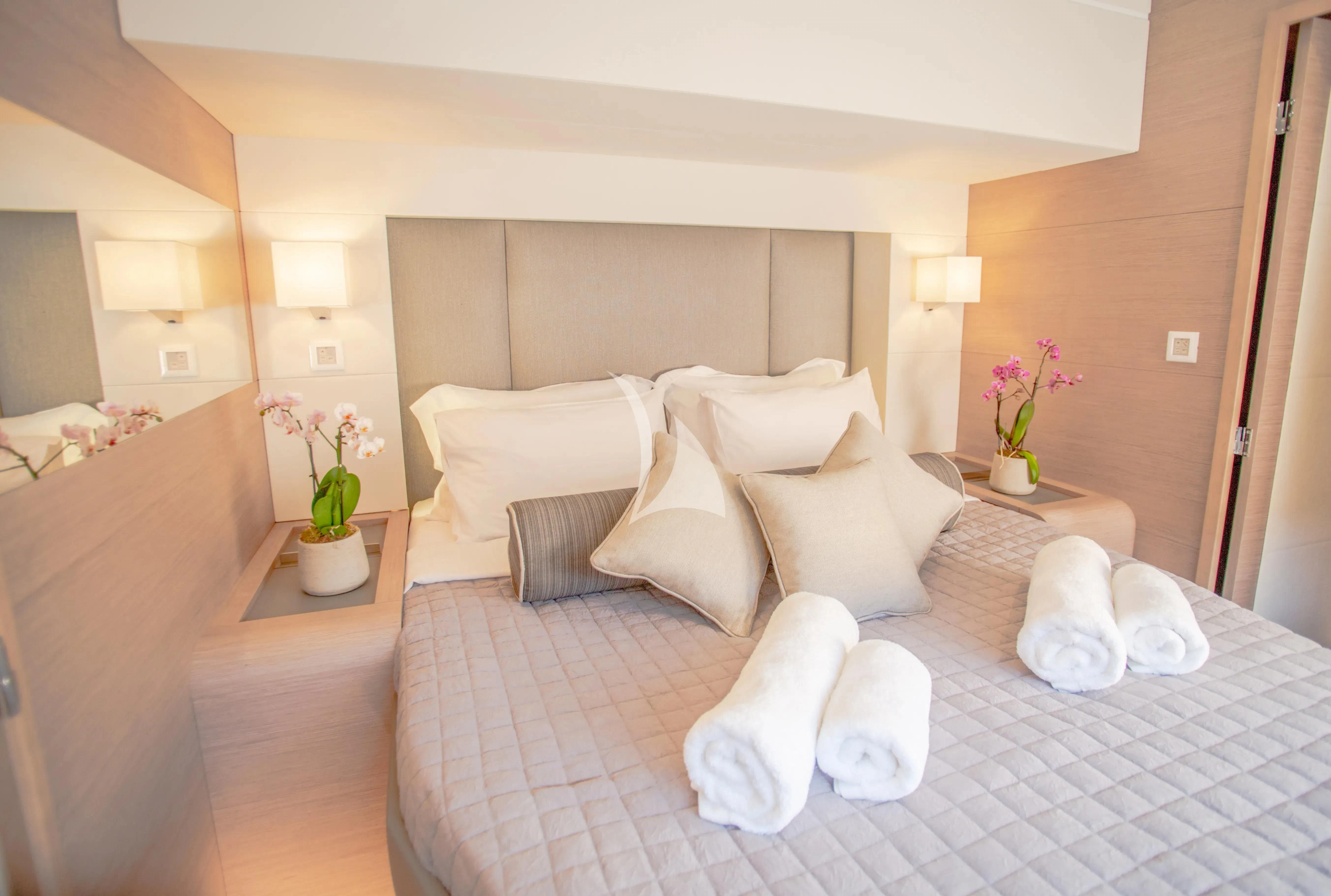 a bed with white pillows aboard MAJESTY OF GREECE Yacht for Charter