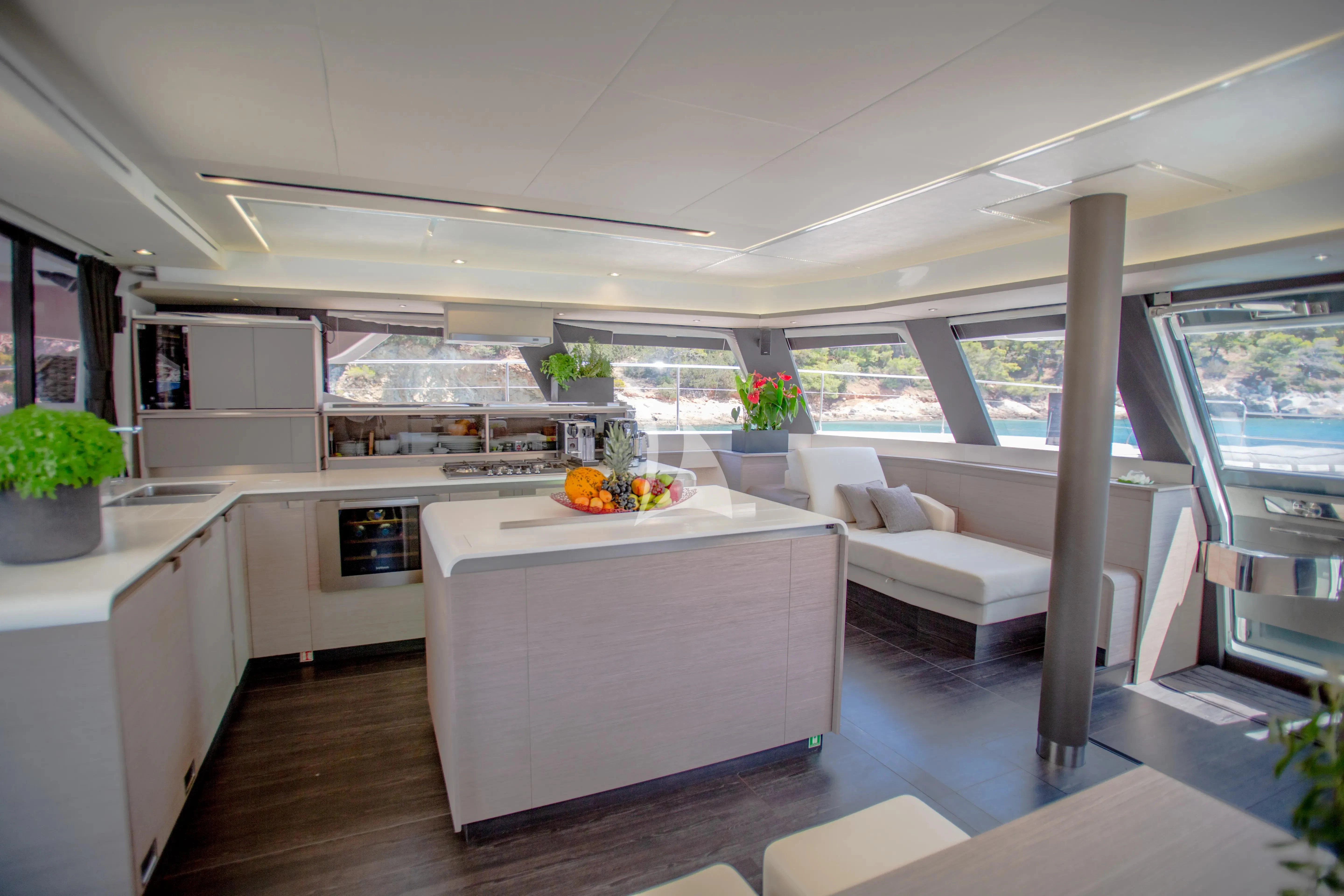a modern kitchen with white furniture aboard MAJESTY OF GREECE Yacht for Charter