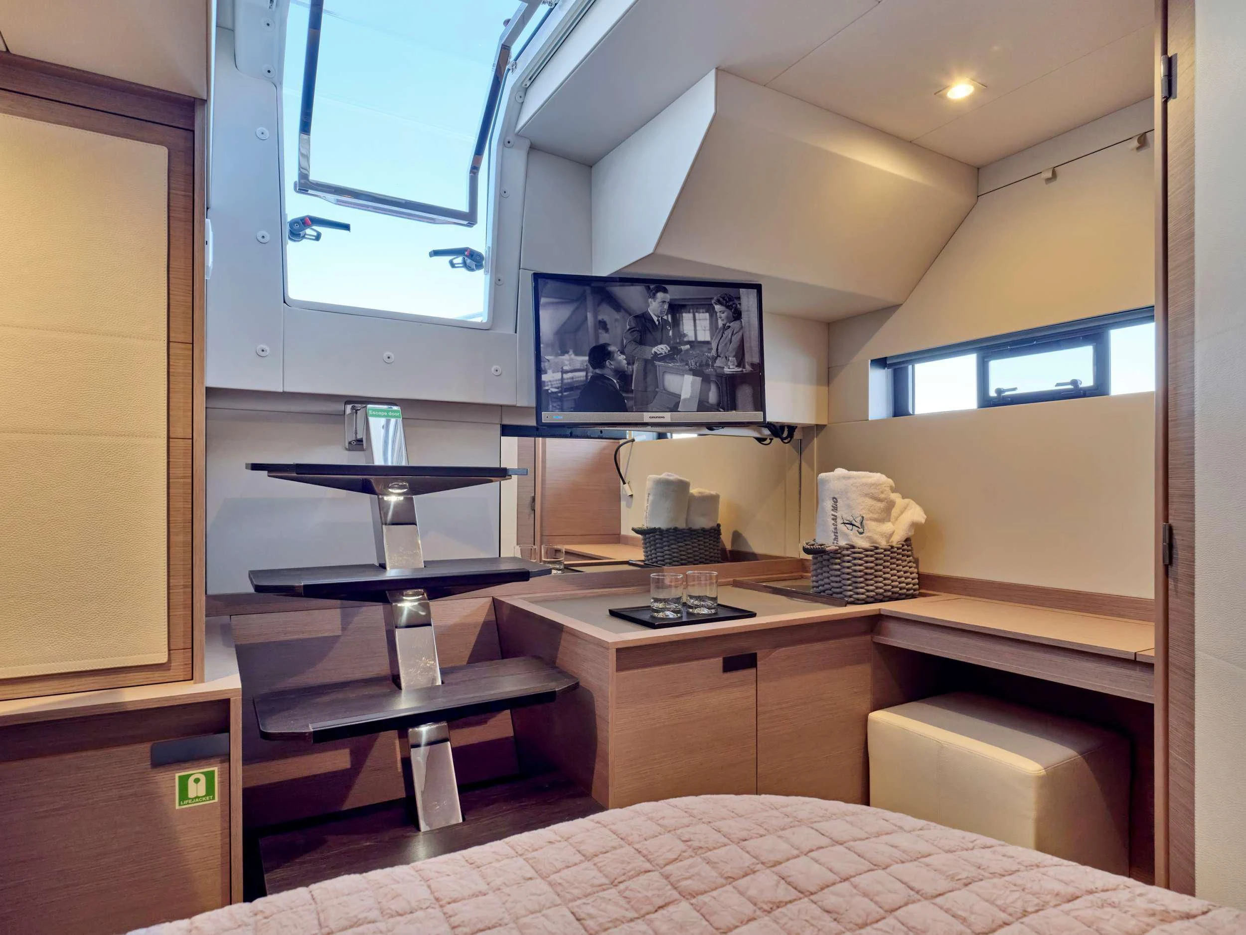 a room with a bed and a tv on the wall aboard MAJESTY OF GREECE Yacht for Charter