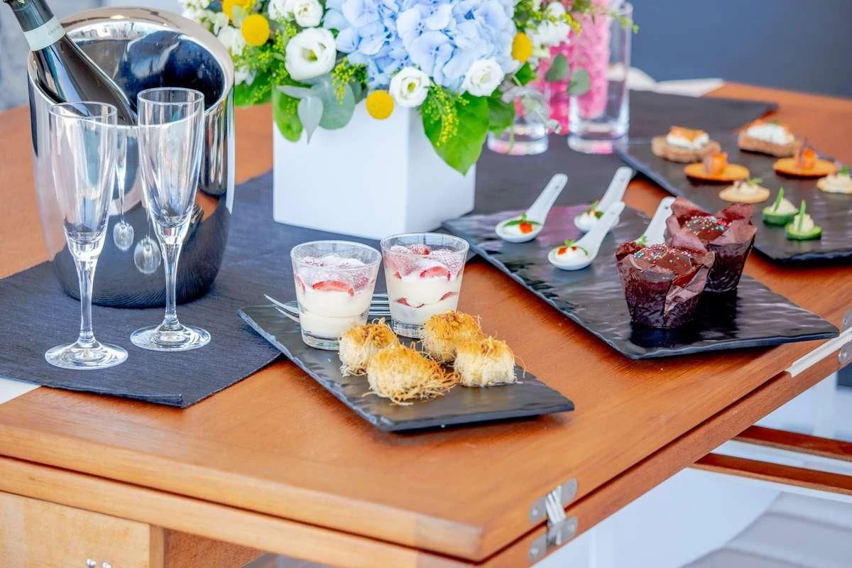 a table with food and glasses aboard MAJESTY OF GREECE Yacht for Charter