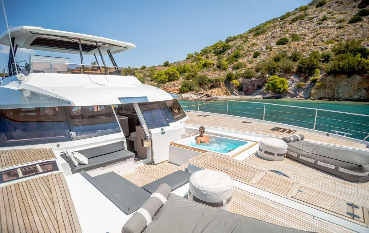 a person sitting on a deck of a boat aboard MAJESTY OF GREECE Yacht for Charter