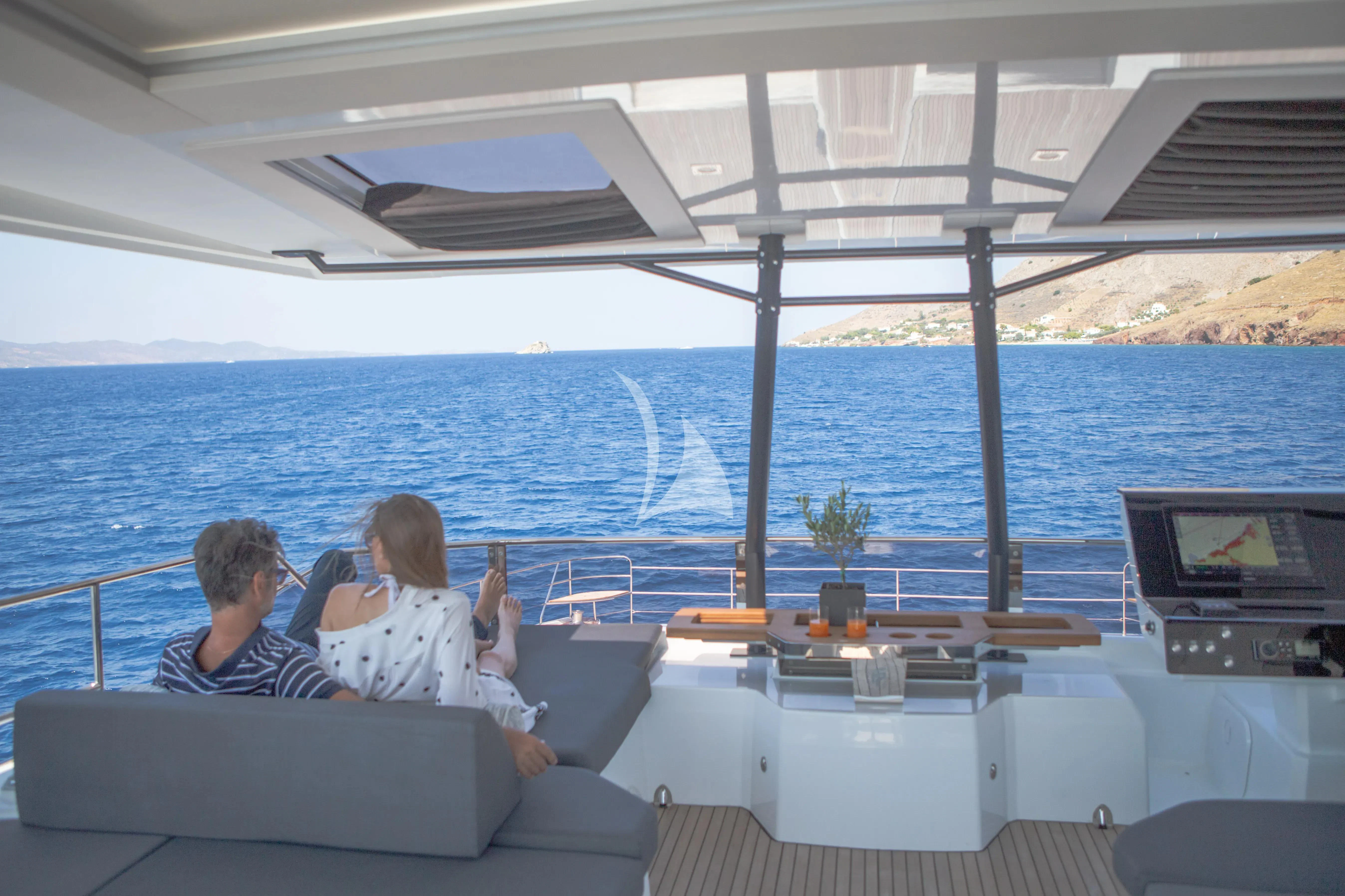 a couple of people sitting on a couch on a boat aboard MAJESTY OF GREECE Yacht for Charter
