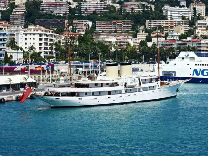 a large white boat in a harbor aboard TALITHA Yacht for Sale