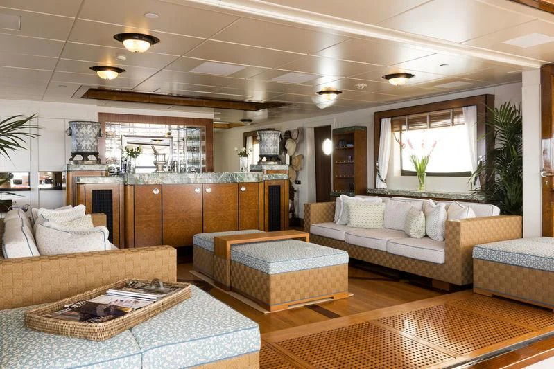 a living room with a couch and a coffee table aboard TALITHA Yacht for Sale