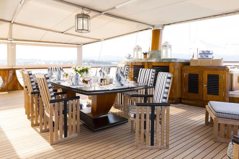 a large kitchen with a table and chairs aboard TALITHA Yacht for Sale