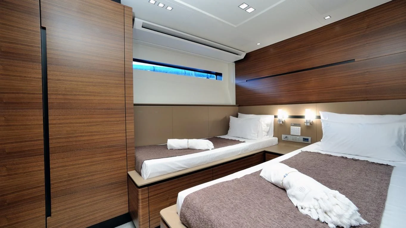 a room with a couple of beds aboard QUASAR Yacht for Sale