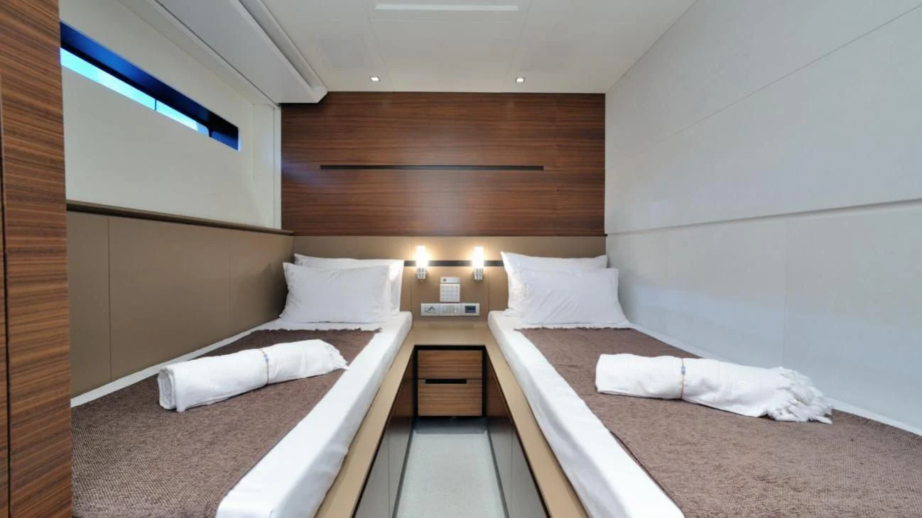 a room with two beds aboard QUASAR Yacht for Sale
