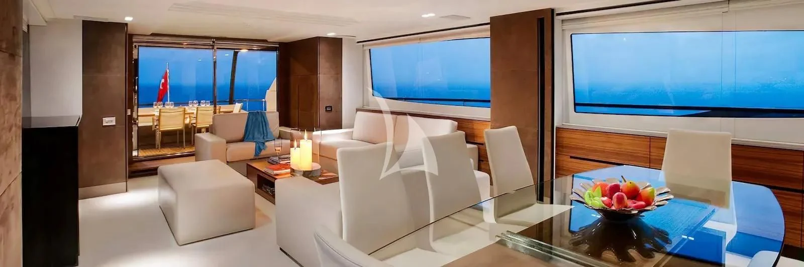 a room with a table chairs and a tv aboard QUASAR Yacht for Sale