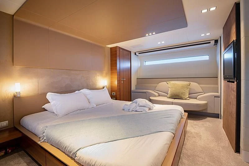 a hotel room with a bed and a couch aboard QUASAR Yacht for Sale