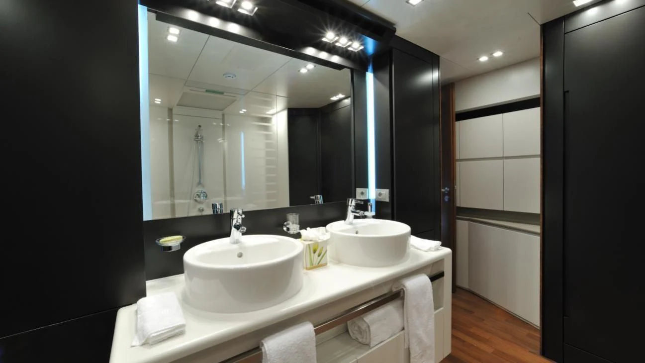 a bathroom with a large mirror aboard QUASAR Yacht for Sale