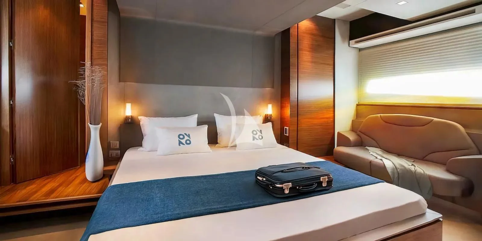 a hotel room with a bed and a couch aboard QUASAR Yacht for Sale