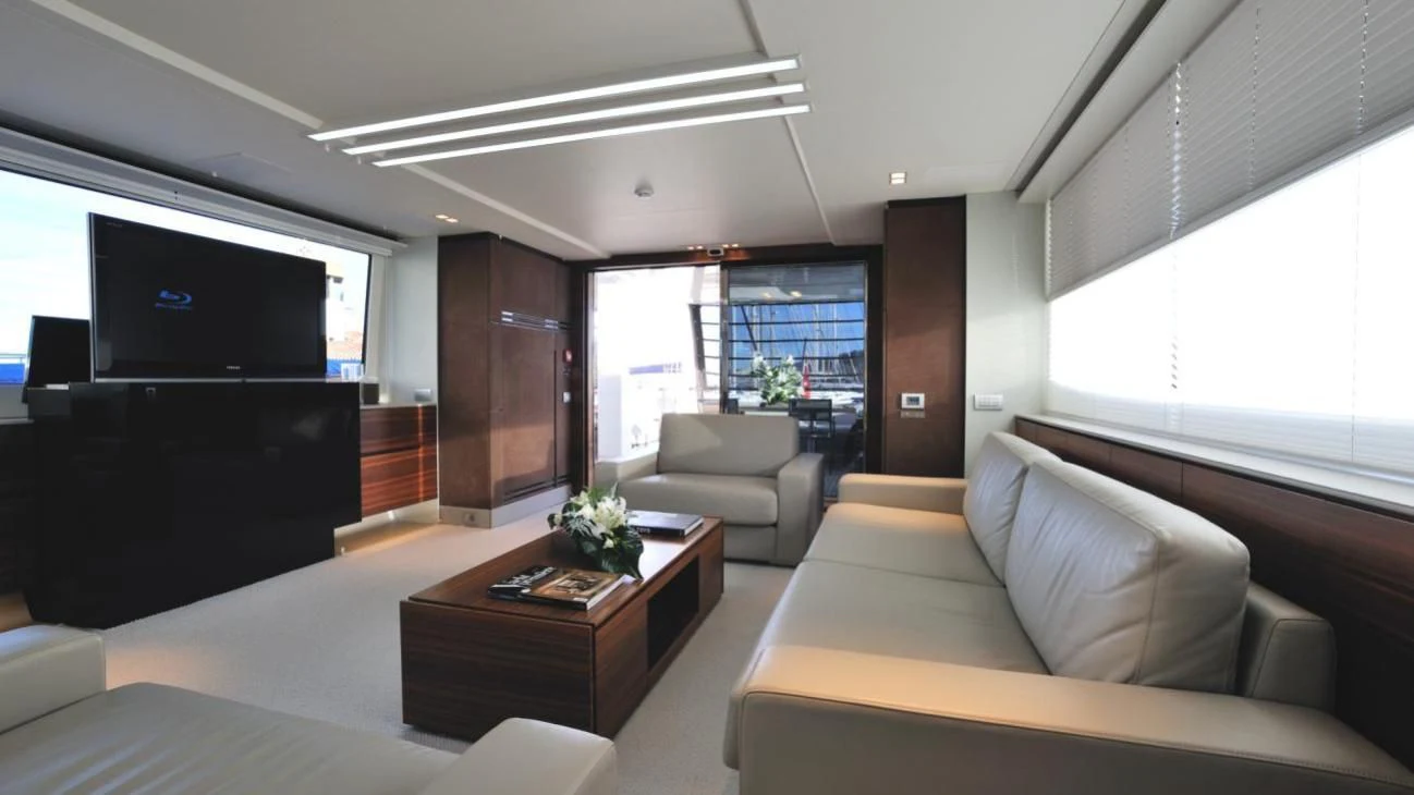a living room with a couch and a tv aboard QUASAR Yacht for Sale