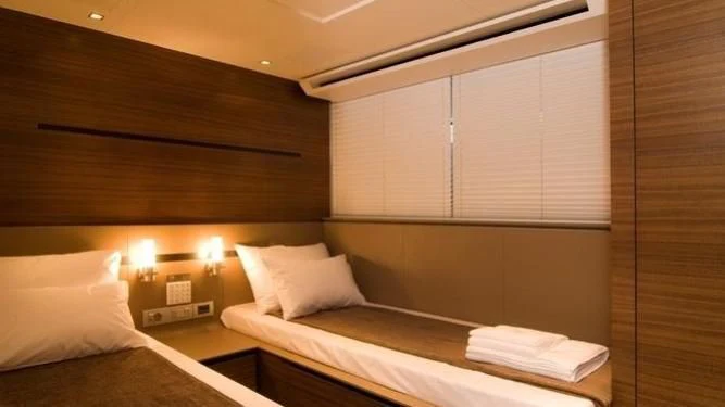 a room with two beds aboard QUASAR Yacht for Sale