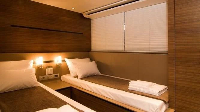 a room with two beds aboard QUASAR Yacht for Sale