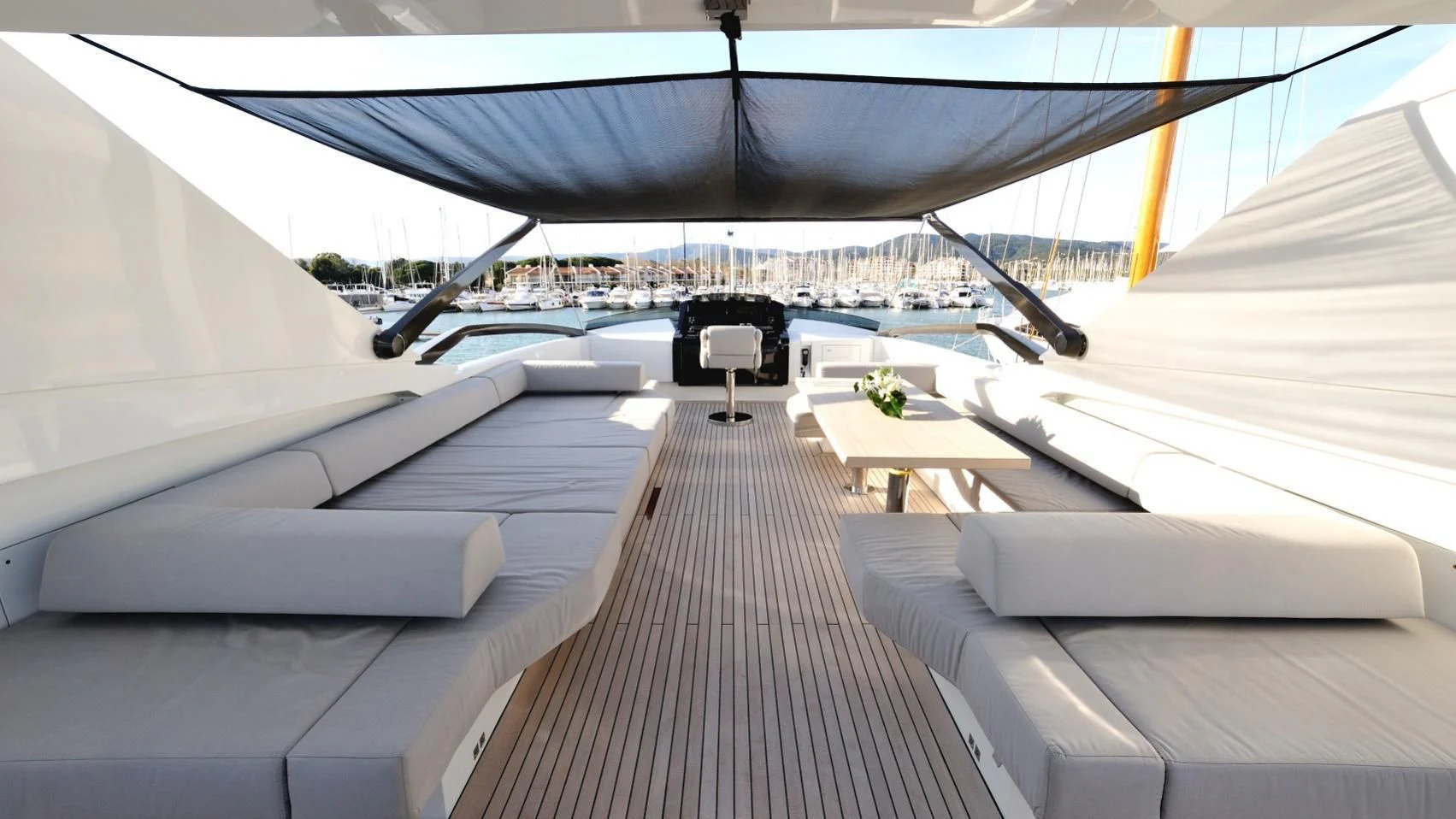 a room with a couch and a table and chairs aboard QUASAR Yacht for Sale