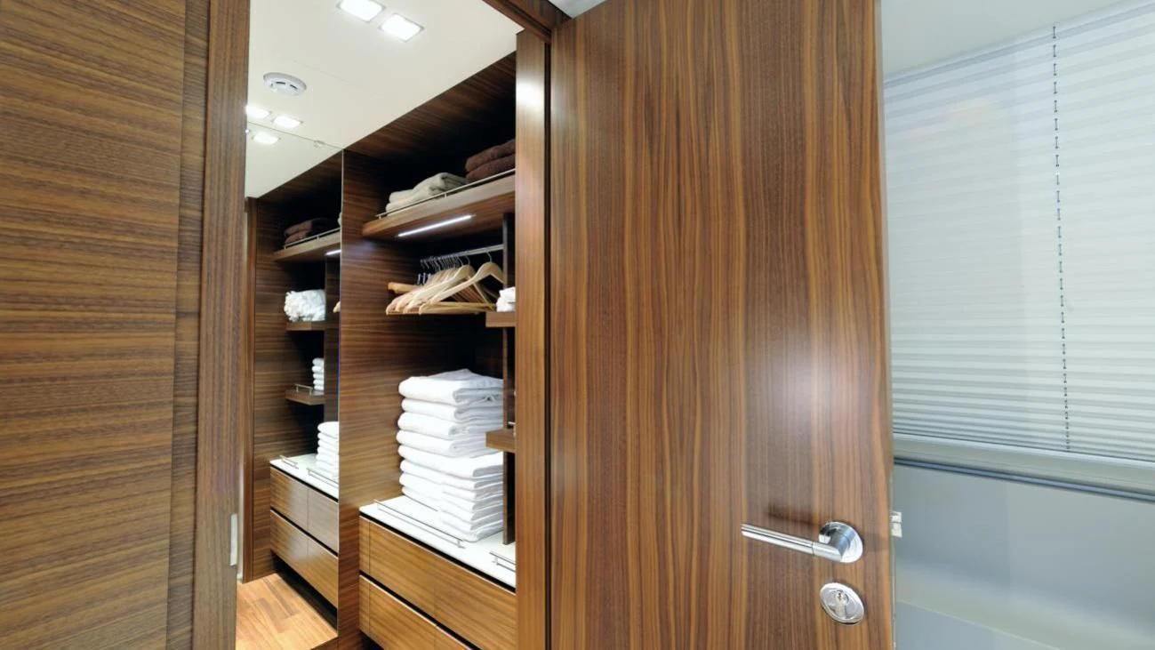 a wooden closet with a door open aboard QUASAR Yacht for Sale