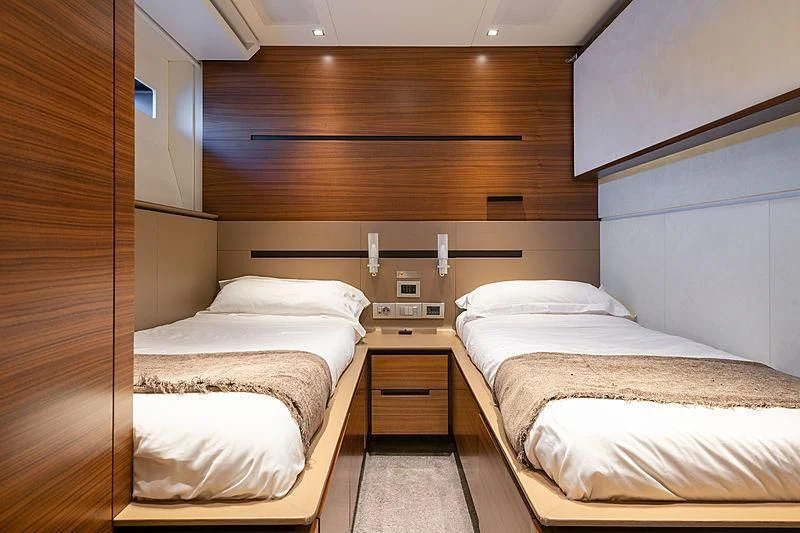 a room with three beds aboard QUASAR Yacht for Sale