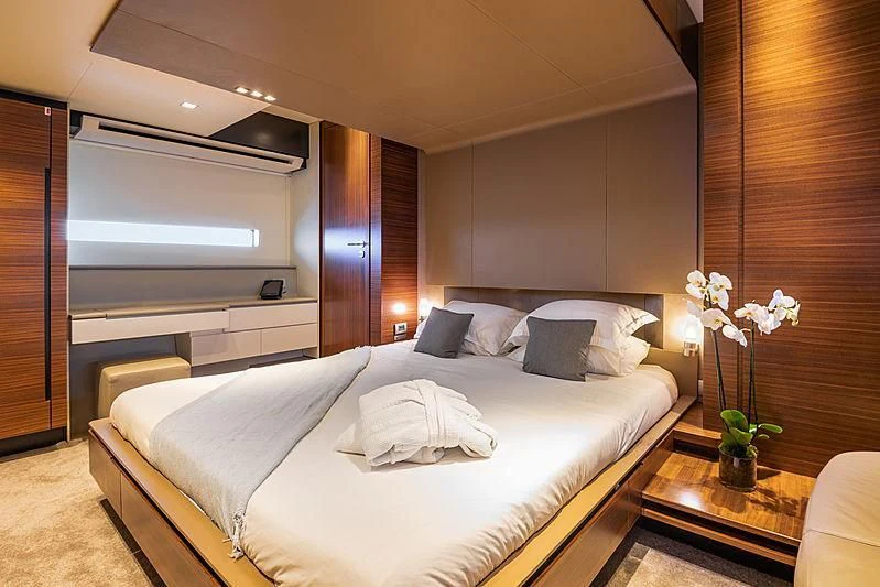 a bed with white sheets aboard QUASAR Yacht for Sale