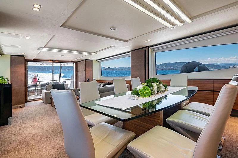 a room with a table and chairs aboard QUASAR Yacht for Sale