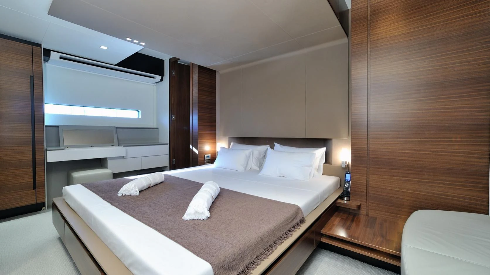 a room with a bed and a desk aboard QUASAR Yacht for Sale