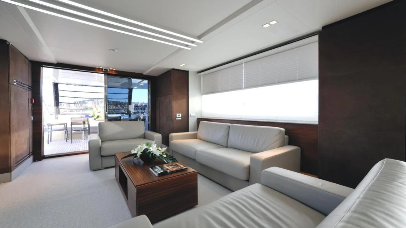 a living room with a couch and a table aboard QUASAR Yacht for Sale