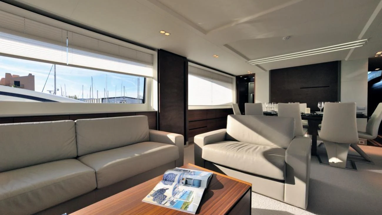 a living room with white couches aboard QUASAR Yacht for Sale