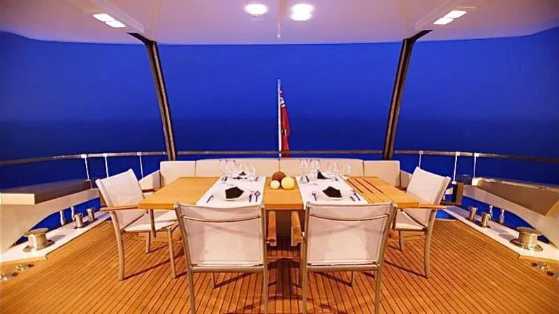 a table with chairs around it aboard QUASAR Yacht for Sale