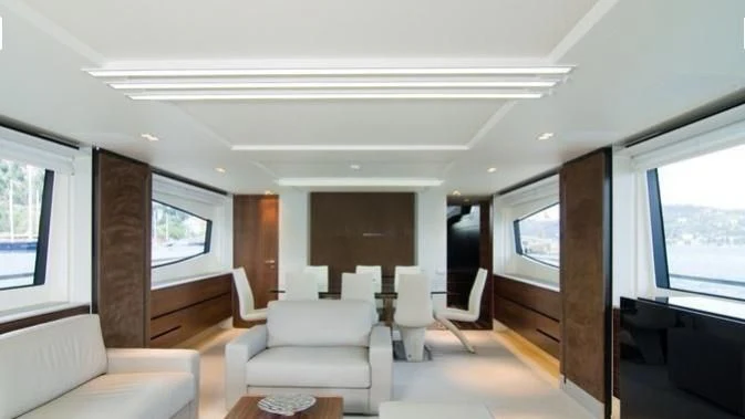 a living room with a wood door aboard QUASAR Yacht for Sale