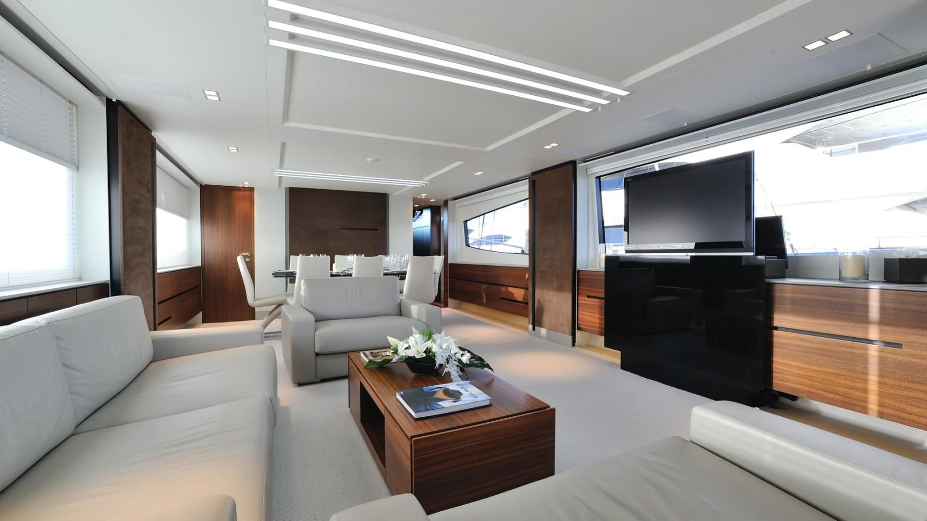 a living room with a tv and couches aboard QUASAR Yacht for Sale