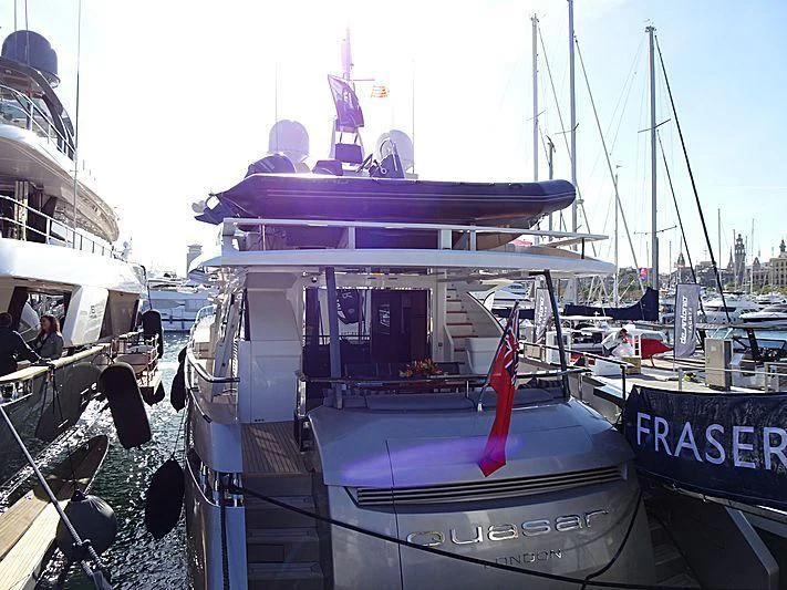 a boat docked in a harbor aboard QUASAR Yacht for Sale