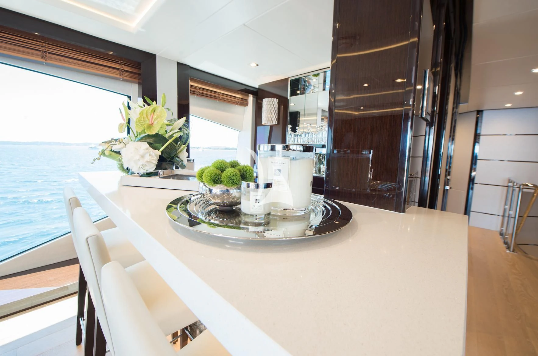a table with a vase of flowers on it aboard E-MOTION Yacht for Sale