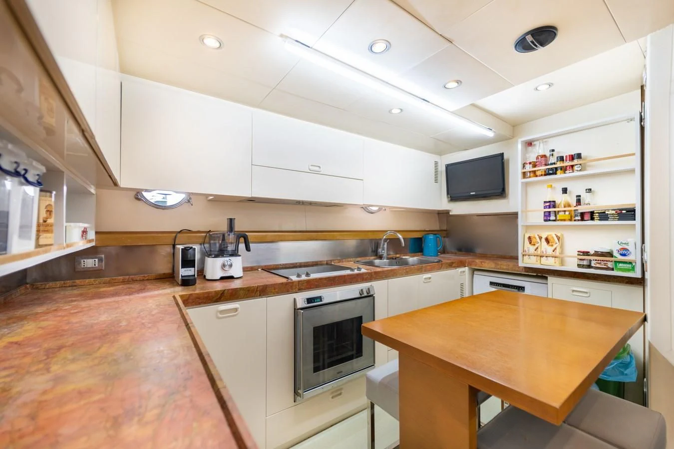 a kitchen with a table and microwave aboard LEONARDO 98 Yacht for Sale
