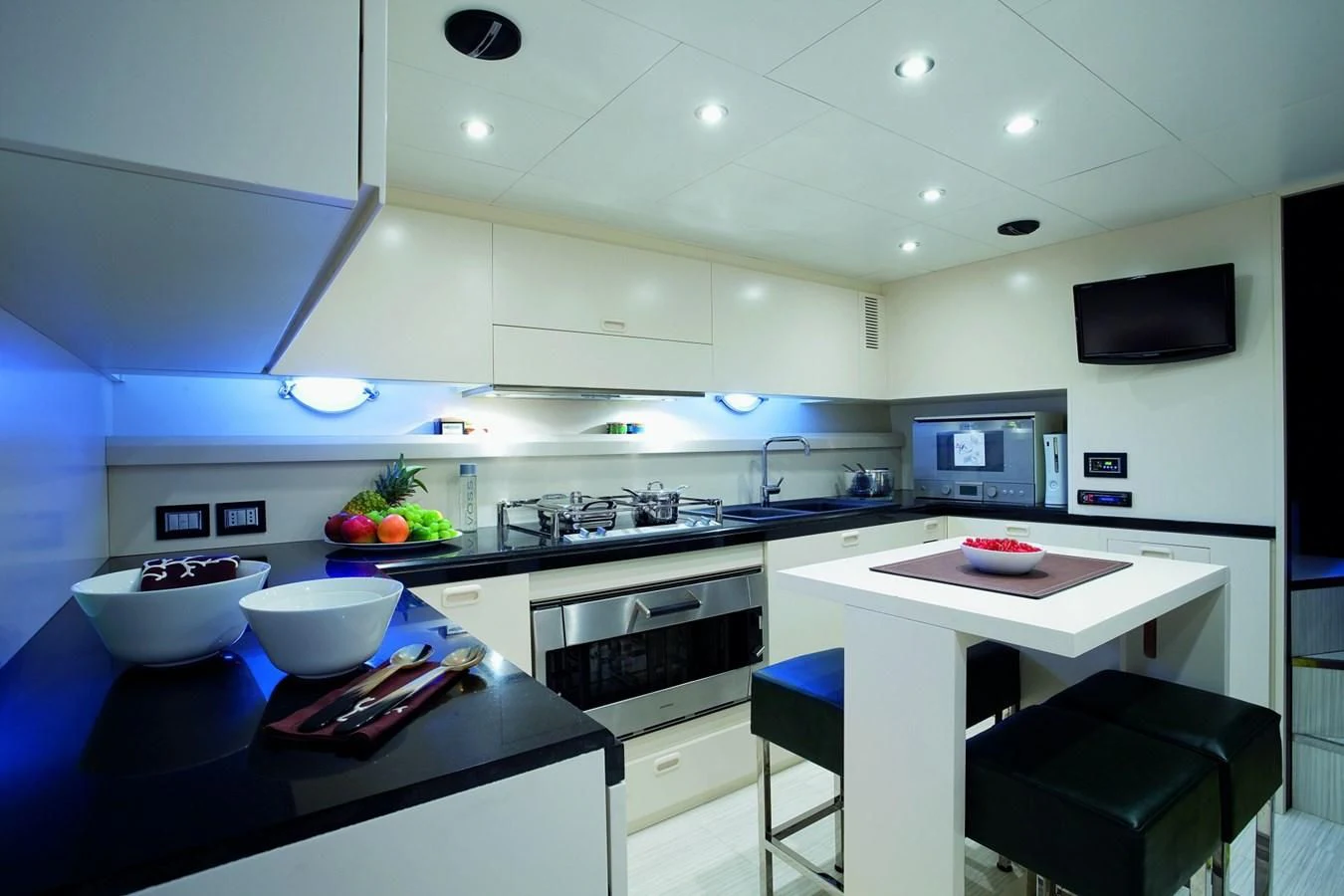 a kitchen with a table and a tv aboard LEONARDO 98 Yacht for Sale