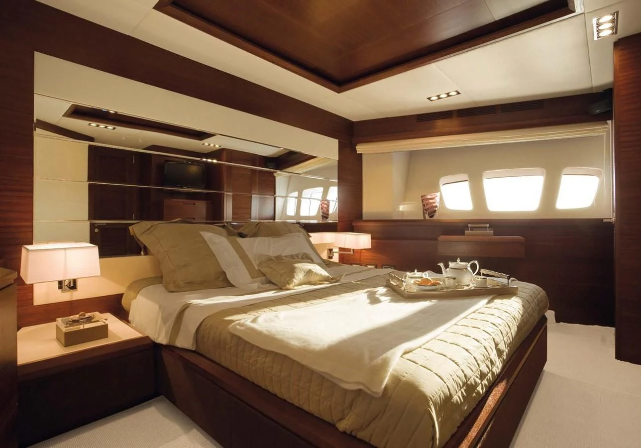a room with a bed and a table aboard LEONARDO 98 Yacht for Sale