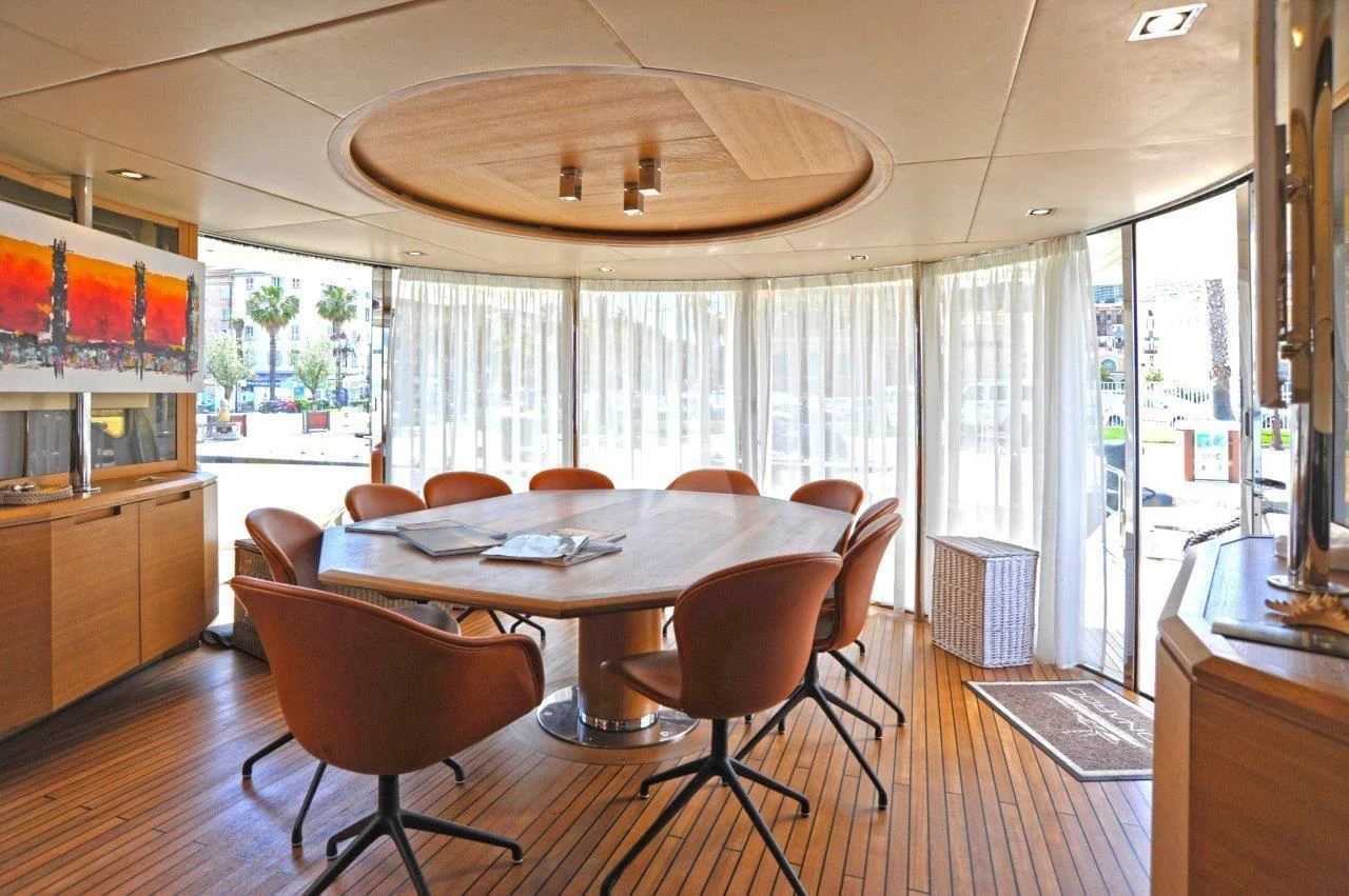 a large kitchen with a dining table aboard LEONARDO 98 Yacht for Sale