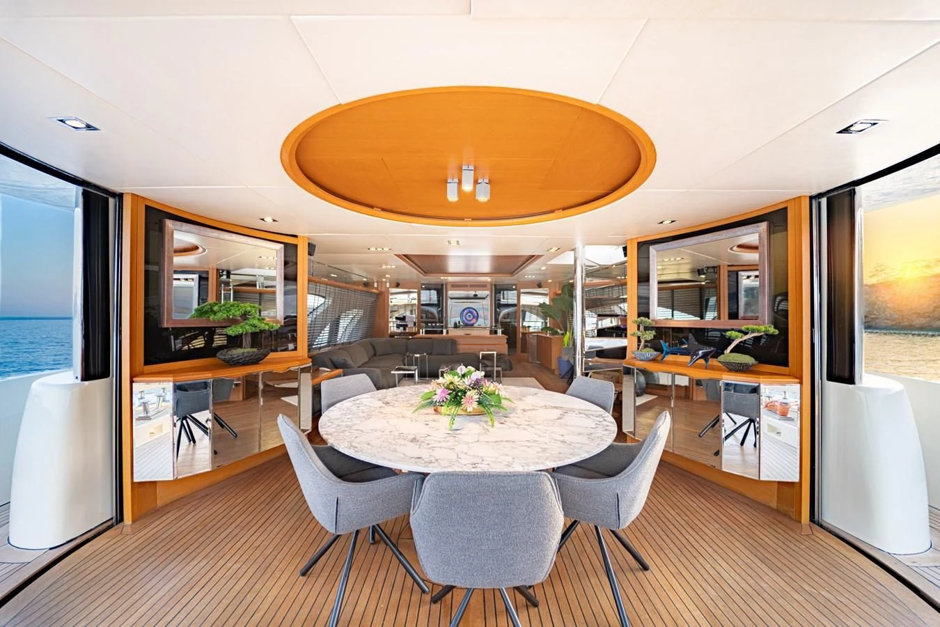 a large room with a table and chairs and a large umbrella aboard LEONARDO 98 Yacht for Sale