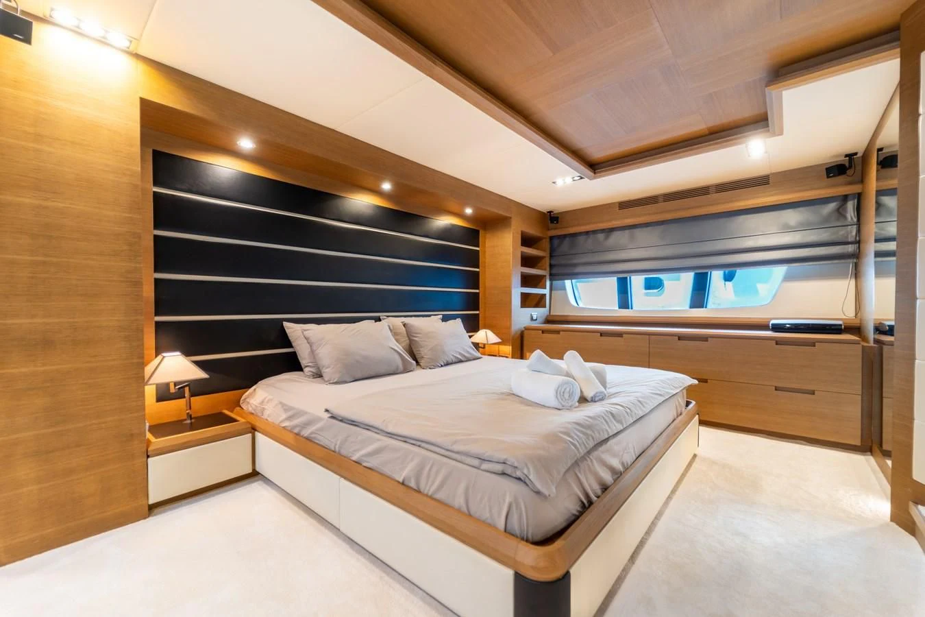 a room with a bed and a desk aboard LEONARDO 98 Yacht for Sale